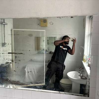 Kurt Hamilton fitting a bathroom mirror